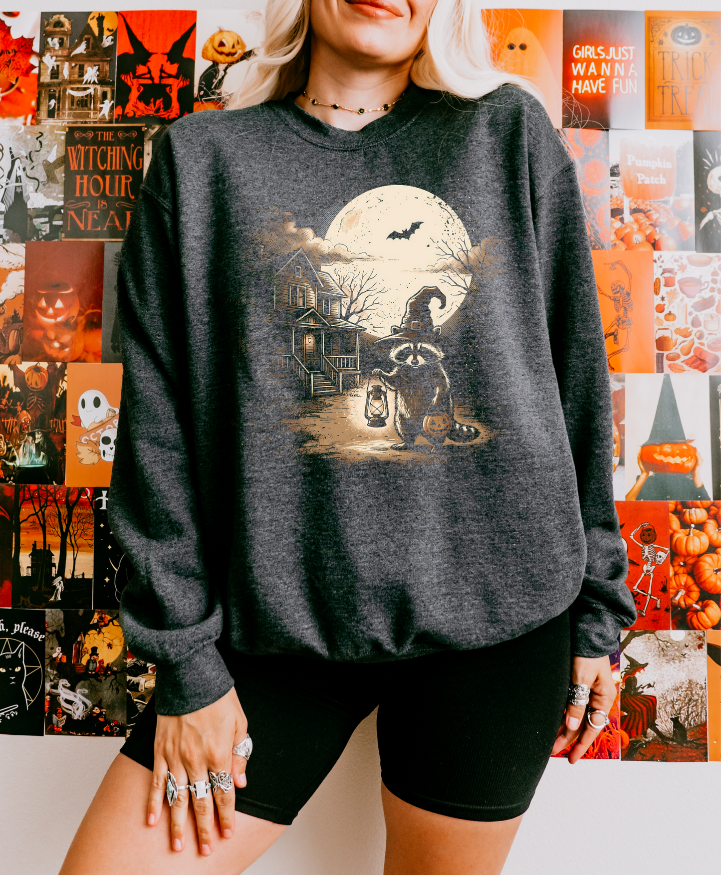 Gildan dark charcoal crewneck with a Halloween raccoon, moon, and haunted house graphic