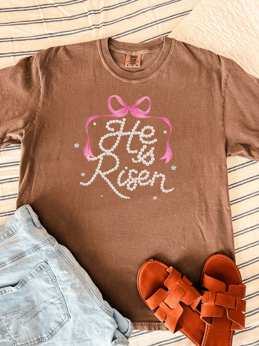 “He Is Risen” Pearl Script Bow Graphic Tee