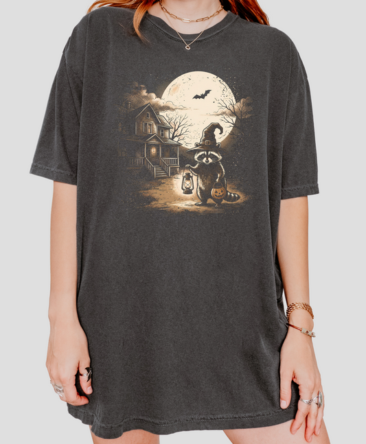 Comfort Colors Pepper tee with a Halloween raccoon, moon, and haunted house graphic