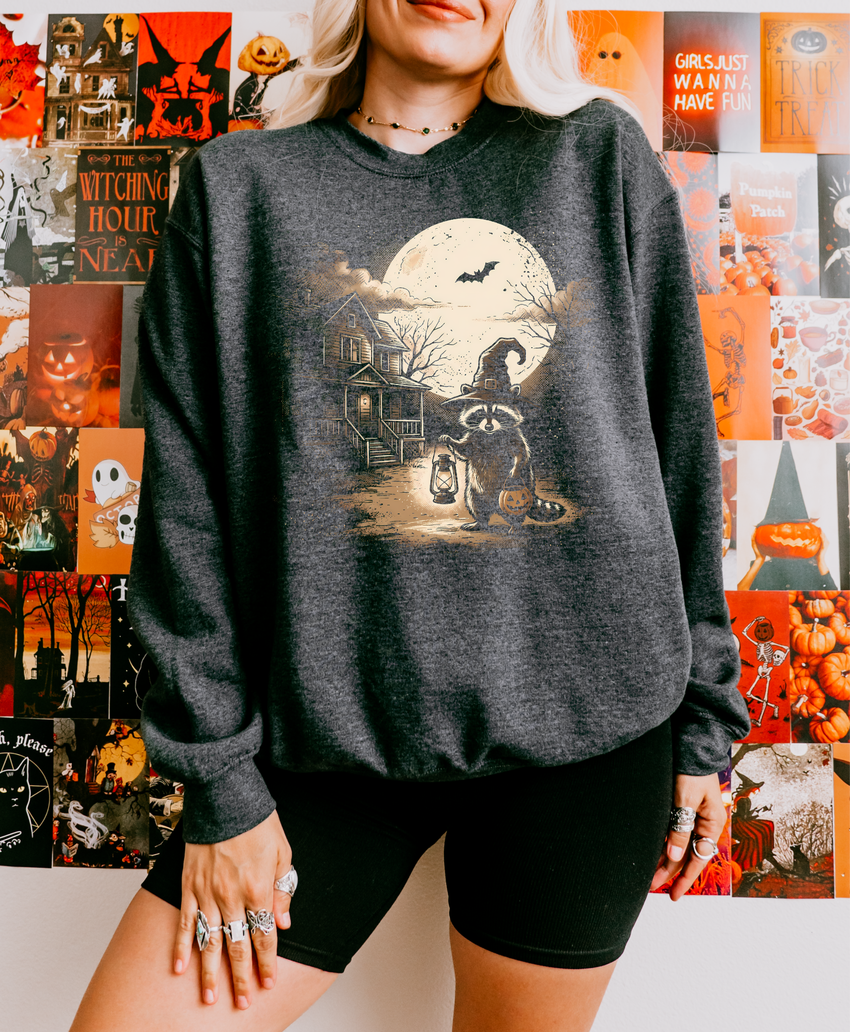 Gildan dark charcoal crewneck with a Halloween raccoon, moon, and haunted house graphic